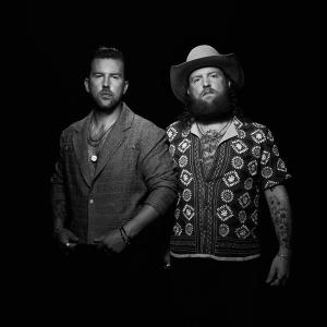 Brothers Osborne stood in a black and white portrait photo.