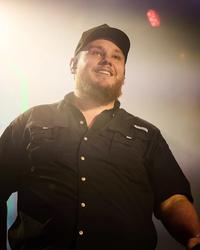Luke Combs smiling on-stage