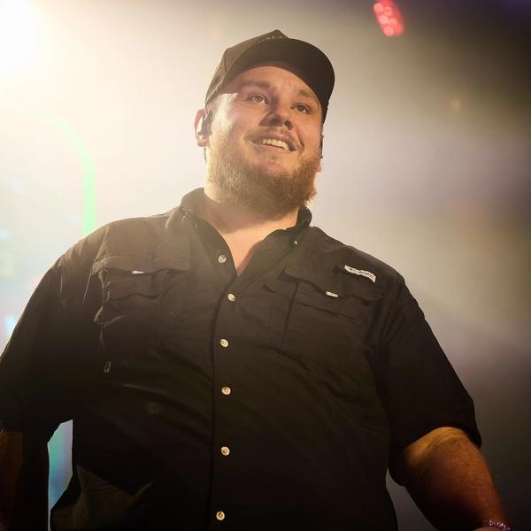 Luke Combs smiling on-stage