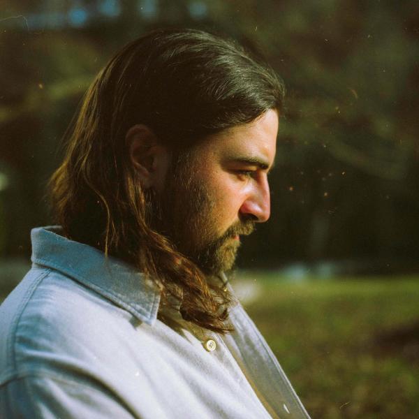 Noah Kahan looking reflective