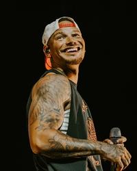 Kane Brown smiling while performing 
