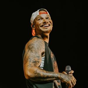 Kane Brown smiling while performing 