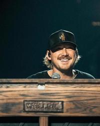 Morgan Wallen playing piano on-stage