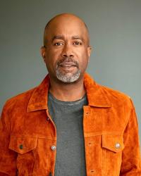 Darius Rucker wearing an orange jacket