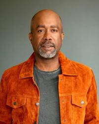 Darius Rucker wearing an orange jacket