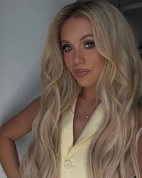 Megan Moroney selfie wearing yellow