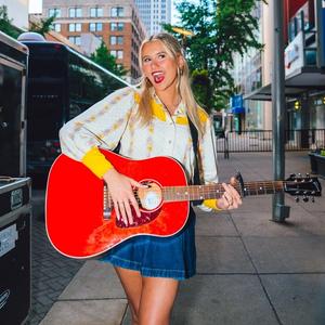 Elizabeth Nichols posing with a guitar in New York