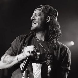 Tyler Hubbard black and white photo of him smiling