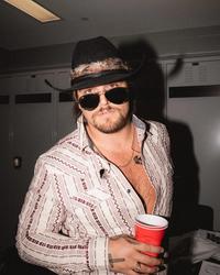 Gavin Adcock looking in the camera with a drink