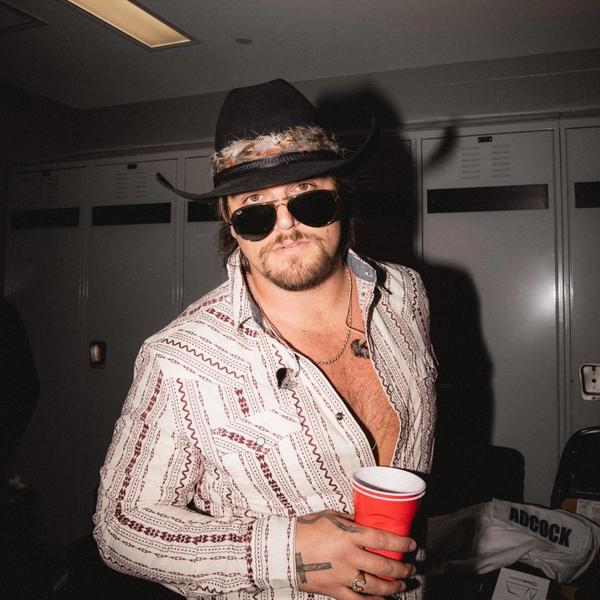 Gavin Adcock looking in the camera with a drink