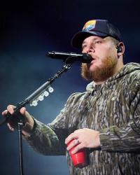 Luke Combs performing in camo