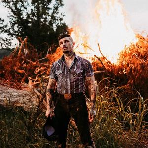 Benjamin Tod in front of a bonfire