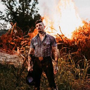 Benjamin Tod in front of a bonfire