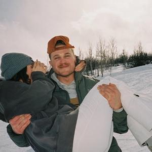 Zach Bryan carries girlfriend Deb Peifer in the snow