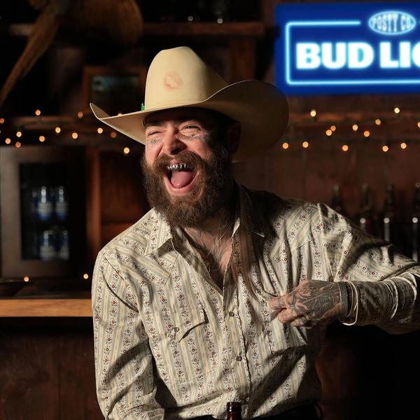 Post Malone laughing in a cowboy hat
