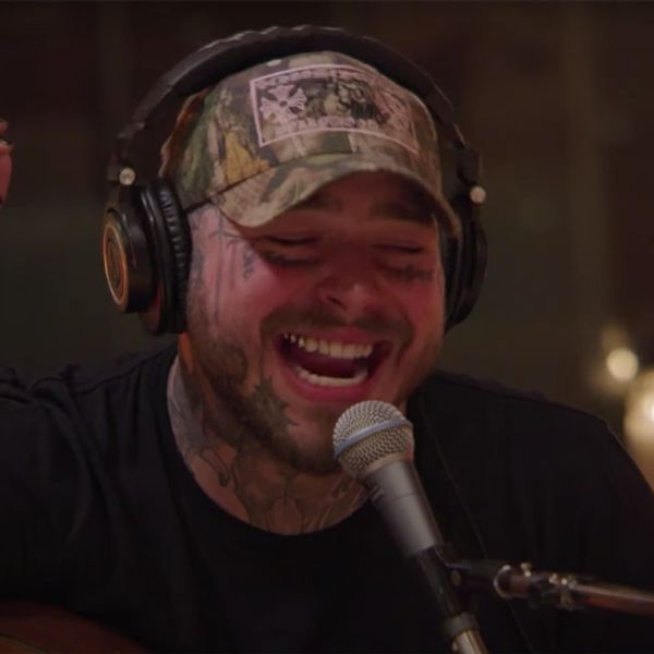 Post Malone singing in a camo hat