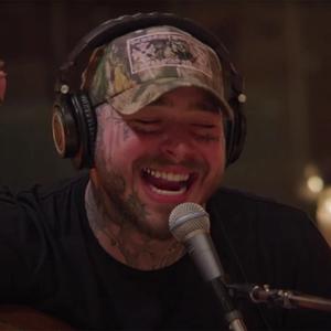 Post Malone singing in a camo hat