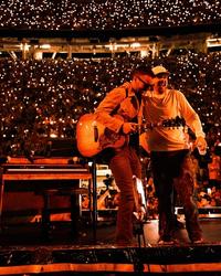 Morgan Wallen performing with Eric Church at Neyland Stadium