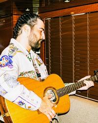 Noah Kahan holding a guitar