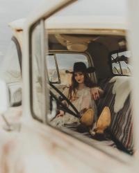 Noeline Hofmann sitting in the cab of a truck, photo taken by Christian Heckle.