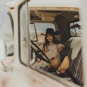 Noeline Hofmann sitting in the cab of a truck, photo taken by Christian Heckle.