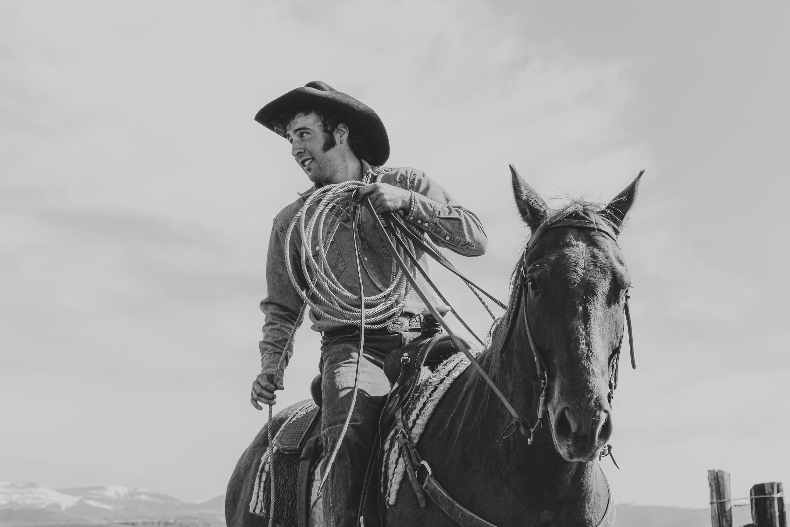 Luke Bell riding a horse with rope in black and white, taken by Mike Vanata.
