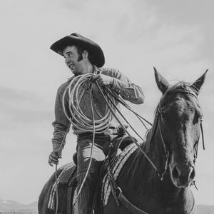 Luke Bell riding a horse with rope in black and white, taken by Mike Vanata.