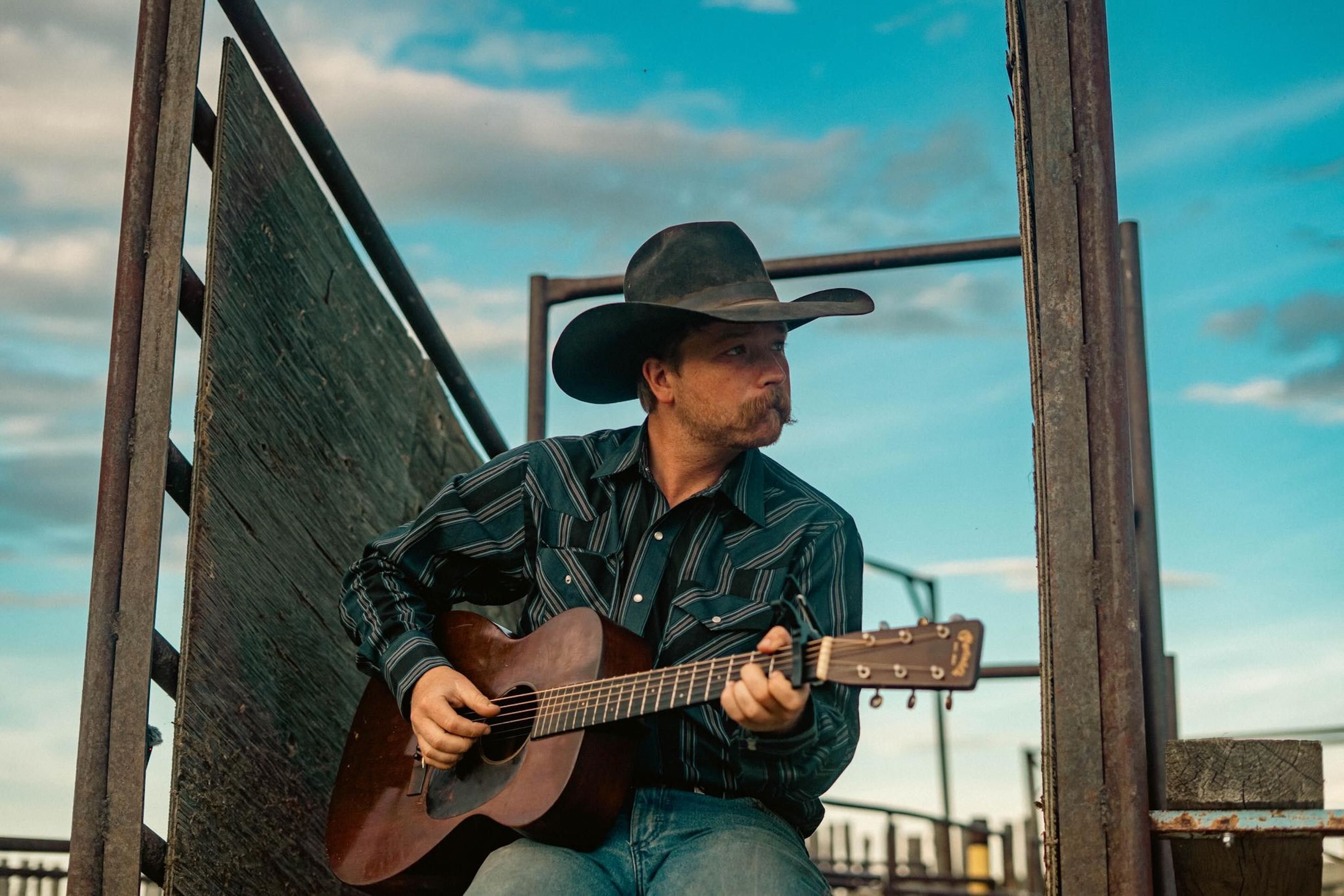 Colter Wall playing guitar on his ranch