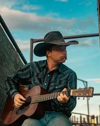 Colter Wall playing guitar on his ranch