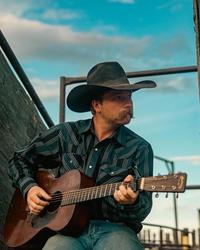 Colter Wall playing guitar on his ranch