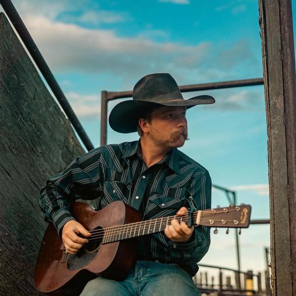 Colter Wall playing guitar on his ranch