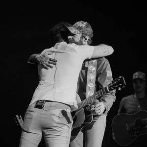 Bobby Bones hugging Post Malone