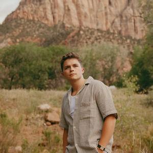 Josiah Queen in front of mountains