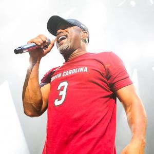 Darius Rucker performing in a red t shirt