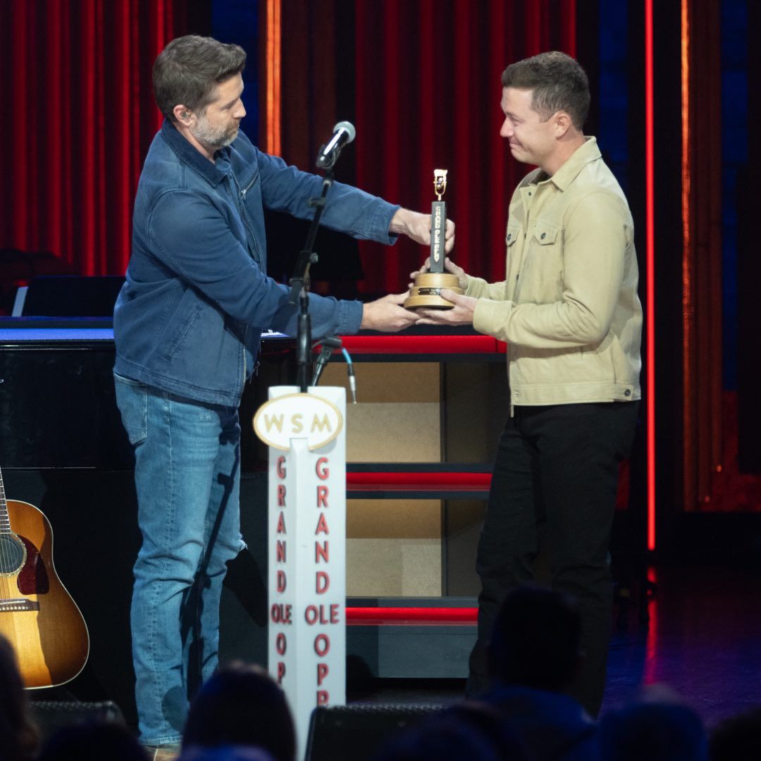 <p>Scotty McCreery getting his Opry induction award from Josh Turner</p>