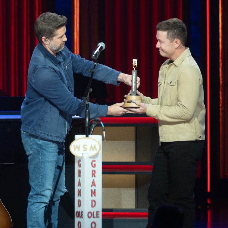 <p>Scotty McCreery getting his Opry induction award from Josh Turner</p>