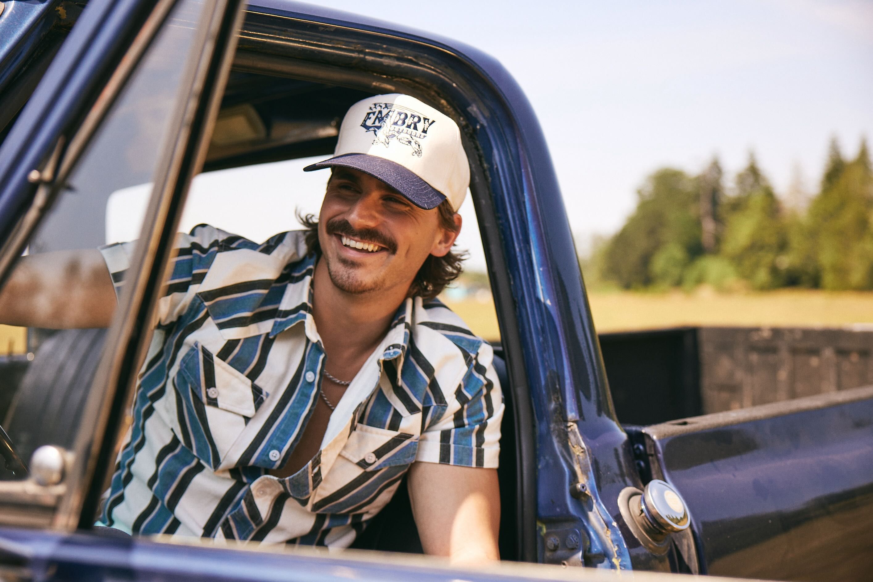 Tucker Wetmore smiling out the side of a car