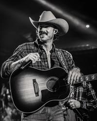 Riley Green performing in a cowboy hat