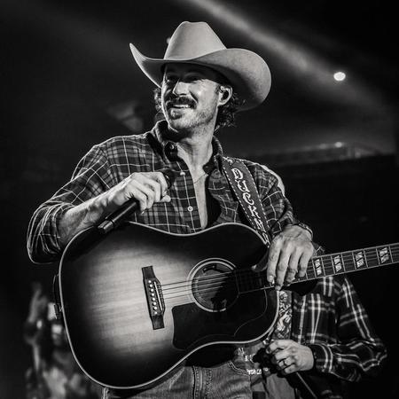Riley Green performing in a cowboy hat