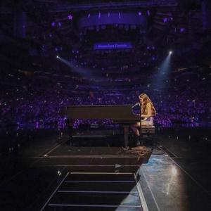 Olivia Rodrigo playing the piano on-stage