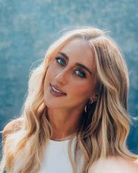 A photo of Ashley Cooke wearing a blue top