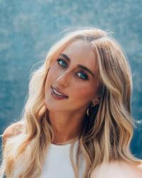 A photo of Ashley Cooke wearing a blue top