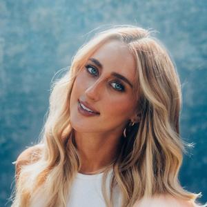 A photo of Ashley Cooke wearing a blue top