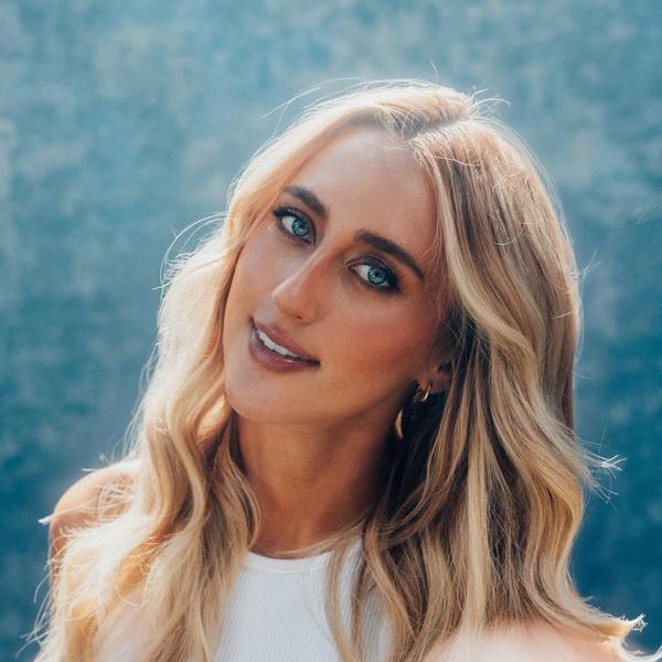 A photo of Ashley Cooke wearing a blue top