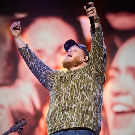 Luke Combs performing in camo