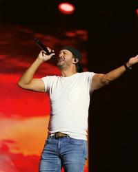 Luke Bryan performing in a white t shirt