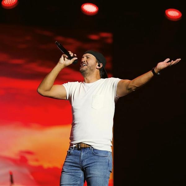 Luke Bryan performing in a white t shirt