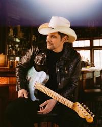 Brad Paisley sat with his guitar in a bar