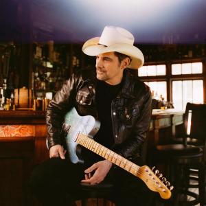 Brad Paisley sat with his guitar in a bar
