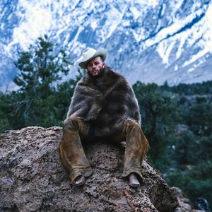 Charley Crockett sat on a rock